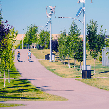 Residents Biking Around Seton Brookfield Residential Community Southeast Calgary