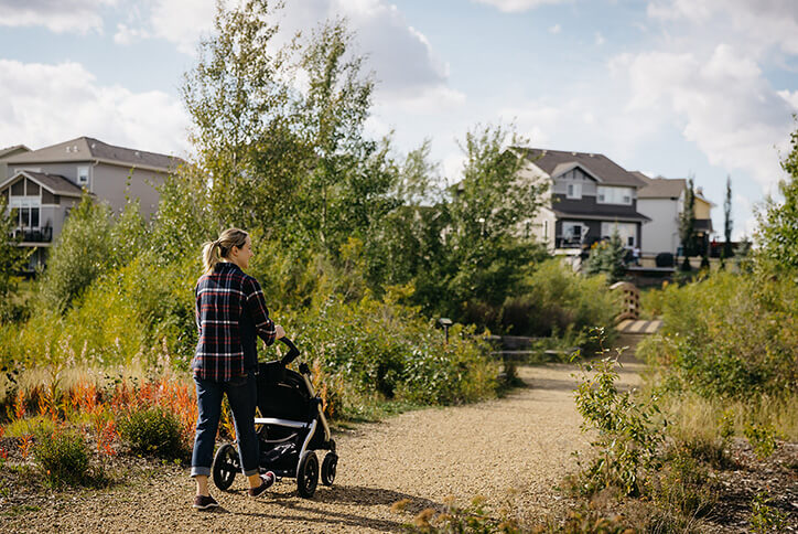 Mother walking with child in Seton community in Calgary, Alberta