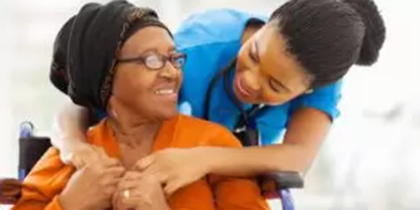 Senior Woman With Wheelchair and Nurse in Agecare Seton